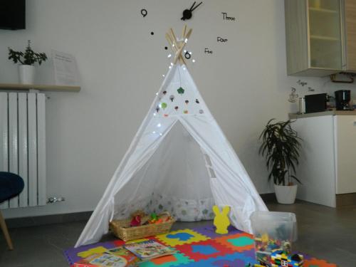 a white teepee tent in a room with a table at Lago Maggiore Holiday House with Panoramic Views in Dumenza