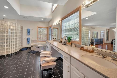 a bathroom with a sink and a large window at Poconos Playtime Paradise Luxury Play Escape in Pocono Pines