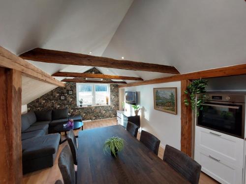 a living room with a table and a couch at Apartment Gasstorp Wifi in Hova