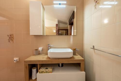 a bathroom with a sink and a mirror at Villa Bonaria Vacation Home in Capoterra