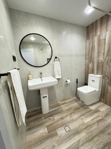 a bathroom with a sink and a toilet and a mirror at SamMar B&B in Ashtarak