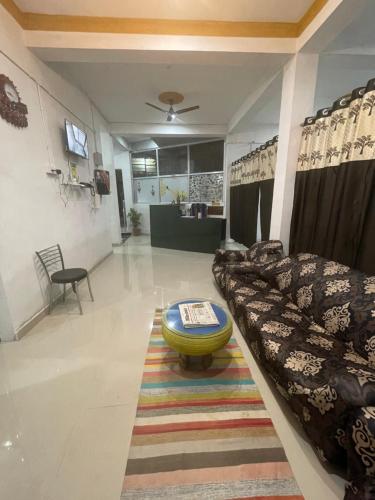 a living room with a couch and a table at Maa Janki Dormitory in Sītāmarhi