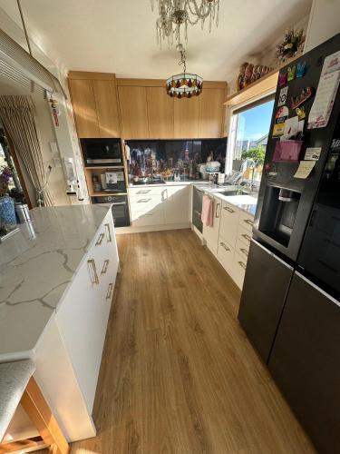 a kitchen with white cabinets and a counter top at sweet house in Auckland
