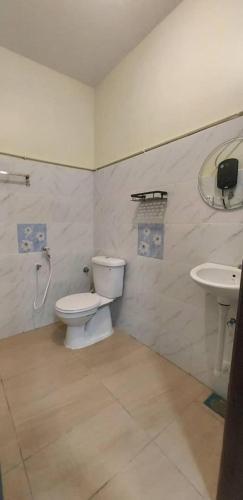 a bathroom with a toilet and a sink at Hotel Bestari in Melaka