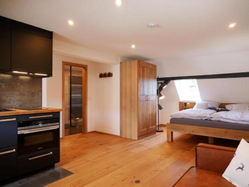 a bedroom with a bed and a kitchen at Rinken9 in Hinterzarten