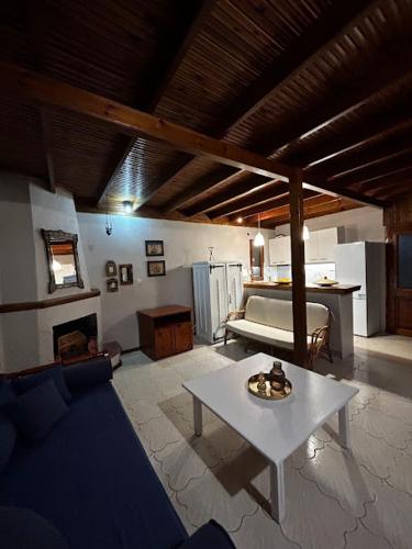 a living room with a table and a couch at Onar in Olympiaki Akti