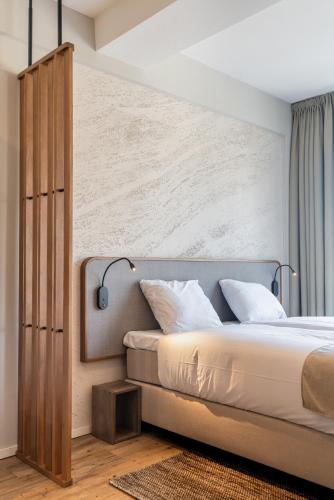 a bedroom with a large bed and a wall at Utrecht City Apartments - Huizingalaan in Utrecht