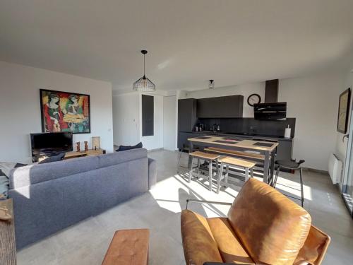 un salon avec un canapé et une table dans l'établissement La Perle des Alizés, à Mimizan-Plage