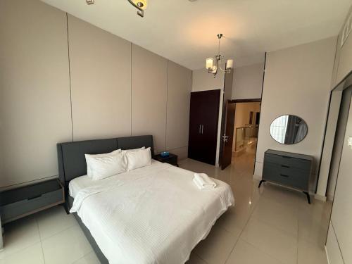 a bedroom with a large white bed and a mirror at 4BR Luxury Retreat & Prvt Pool in Sharm