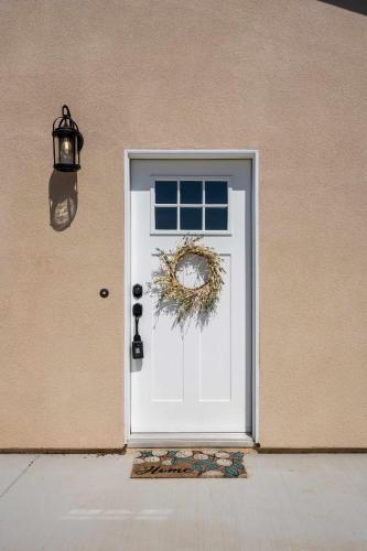 a white door with a wreath on it at The Little Oasis in Escondido