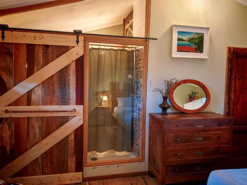 a bedroom with a wooden barn door and a dresser at Agriturismo Podere Orzale Hospitality & Quarter Horses in Usigliano