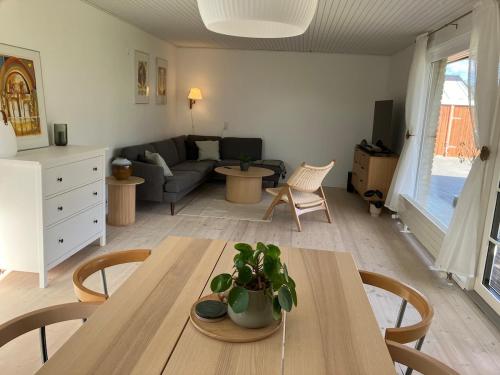 a living room with a table and a couch at House close to city center, beach and Great Northern in Kerteminde