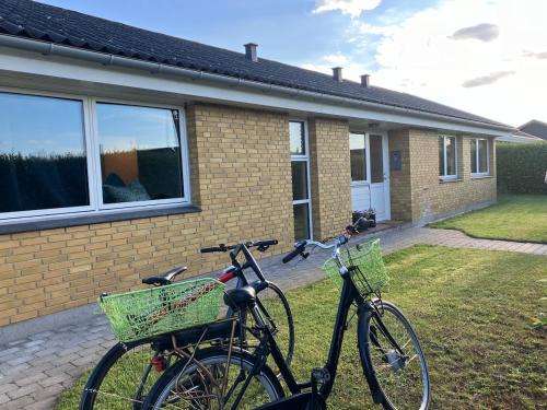 two bikes parked in front of a house at House close to city center, beach and Great Northern in Kerteminde