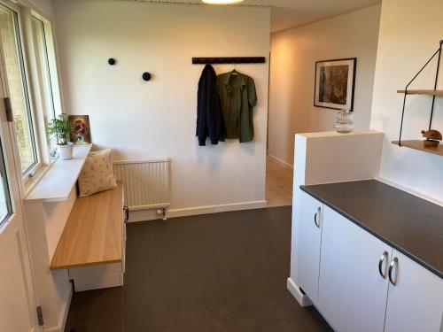 a dressing room with a coat hanging on a wall at House close to city center, beach and Great Northern in Kerteminde