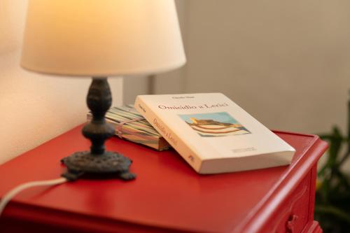 a book sitting on top of a table next to a lamp at Sea & Culture in Lerici