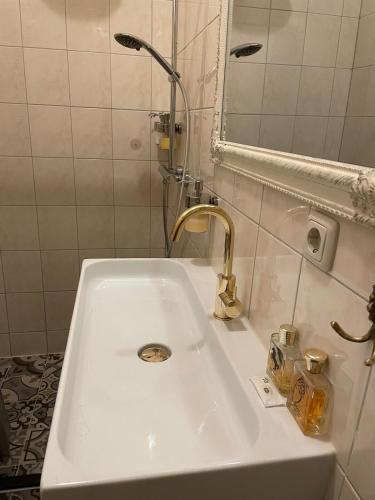 a white sink in a bathroom with a mirror at LUXURIOUS classical dutch styled ROOM in city centre of The Hague - HOME STAY in The Hague