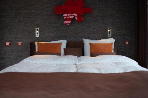 a bedroom with a bed with a red bow on the wall at B&B Carpe Diem in Westerlo