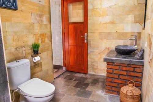 a bathroom with a toilet and a sink at Villa Mulia - 2BR Canggu Bali in Dalung