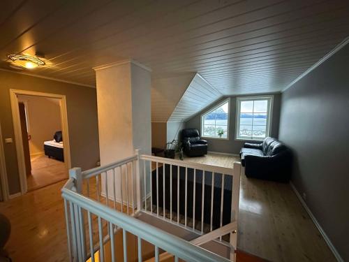 a living room with a couch and a large window at Leiligheit i Hornindal in Volda