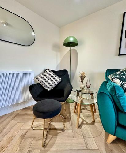 a living room with a chair and a table at Cozy Cottage Retreat in Portsoy