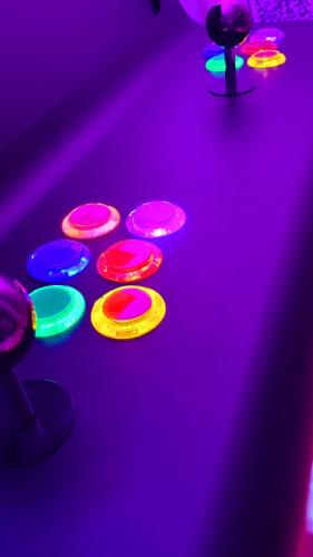 a group of four colored lights on a nightclub floor at Le Nuage - Hypercentre - Luxe Suite Spa & Gaming in Troyes