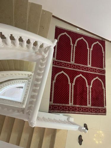 a room with a red and white pattern on the wall at فـالـي ريزيدنـس - Valley Residence in Al Baha
