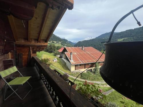 a balcony of a house with a view of a house at Le Fôret - Cergnat in Le Sépey