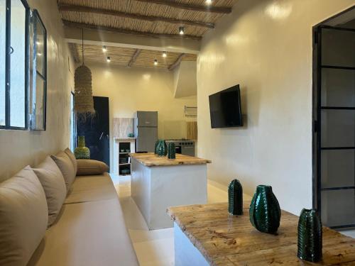 a living room with a couch and a table at Simple Moroccan Rural Getaway in Tama ou Ennza