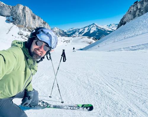 a man on skis in the snow on a mountain at Le Fôret - Cergnat in Le Sépey