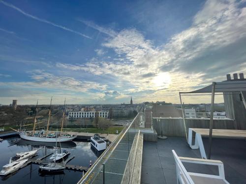a view of a marina with boats in the water at penthouse studio residentie Mercator, in Ostend