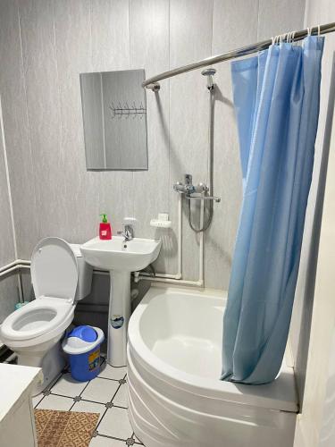 a bathroom with a toilet and a sink and a shower at Madina-Mehribon in Bukhara