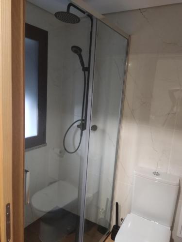 a shower in a bathroom with a toilet and a window at Casa do Moinho in Pampilhosa da Serra