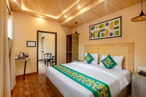 a bedroom with a large bed in a room at Treebo Lords Garden Glory in Shimla
