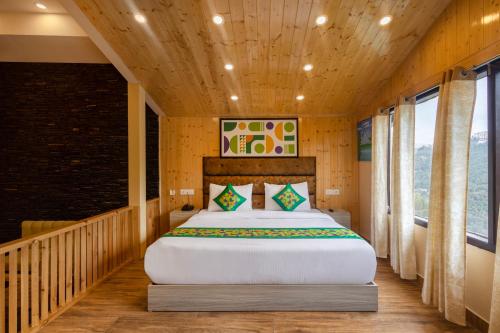a bedroom with a large bed in a room at Treebo Lords Garden Glory in Shimla