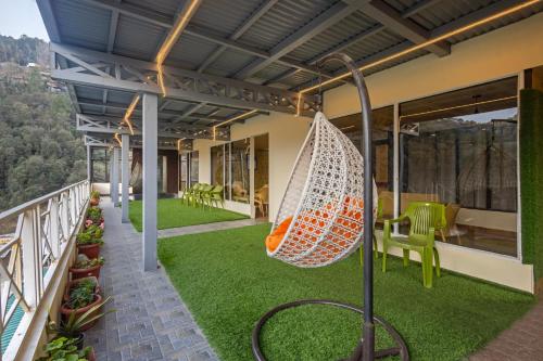 a hammock on the balcony of a house at Treebo Lords Garden Glory in Shimla