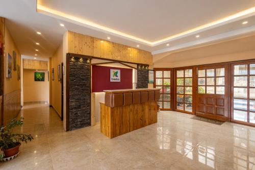 a lobby with a bar in a building at Treebo Lords Garden Glory in Shimla