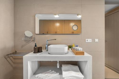 a bathroom with a sink and a mirror at Boutique Hotel Bougainvillea in Kralendijk