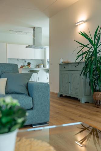 a living room with a blue couch and a table at La Tizzana in Armeno