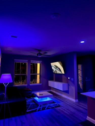 a blue living room with a couch and a table at Luxury 2St Home, By Austin Airport, Gym, Pool in Austin