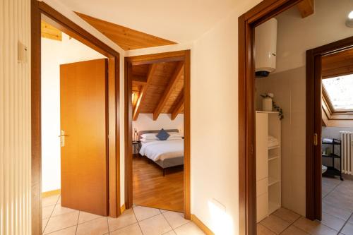 a room with a bed and a door leading to a bedroom at Bernina Express Eco Rooms&Breakfast in Tirano