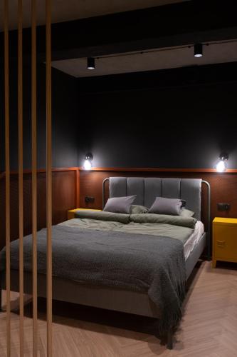 a bedroom with a bed with two pillows at Apartament Nadolnik Poznań in Poznań