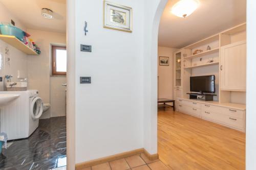 a bathroom with a sink and a tv in a room at Appartamento Iori in Canazei