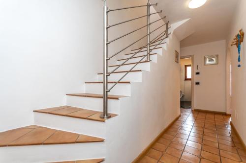a staircase in a home with white walls and wooden floors at Appartamento Iori in Canazei