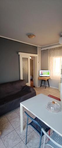 a living room with a bed and a table at Orsiida sea view apartment Agria in Agria
