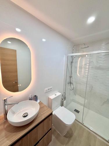 a bathroom with a toilet and a sink and a shower at Apartaments Sant Antoni in Benidorm