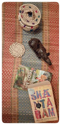 a table with a magazine and a book and a rope at Stargaze Backpackers Shillong in Shillong