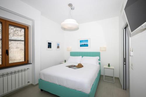 a bedroom with a bed and a window at Villa Leonardo in the heart of Positano in Positano