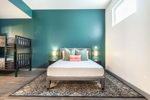 a bedroom with a bed and a blue wall at Spacious Family Suite Near Cherry St - Sleeps 6! in Macon
