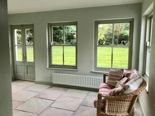 a living room with a couch and windows at Mizzle Cottage in Cloghjordan