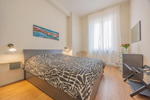 a bedroom with a bed with a black and white comforter at Romeo e Giulietta Suite in Verona